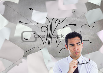 Composite image of thinking businessman holding glasses