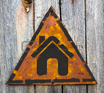 Home Icon on Rusty Warning Sign.