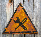 Service Concept on Rusty Warning Sign.