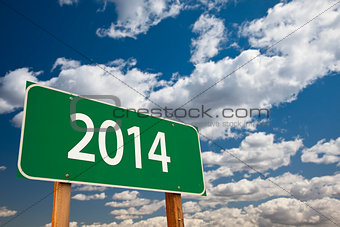 2014 Green Road Sign Over Clouds