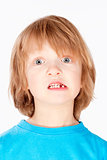 Boy with Blond Hair Showing his Missing Milk Teeth 