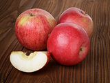ripe red apples on wood table