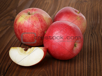 ripe red apples on wood table