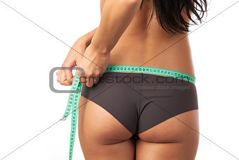 Cropped view of a beautiful young woman measuring her body
