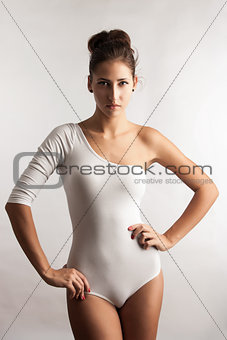 Portrait of a stunning young lady posing over light gray background