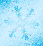 Snowflake on the snow. White xmas holiday background