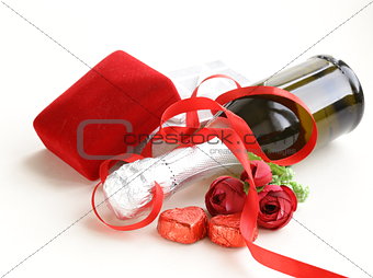 Festive bottle of champagne with chocolate and gifts