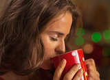 Portrait of young woman enjoying cup of hot chocolate