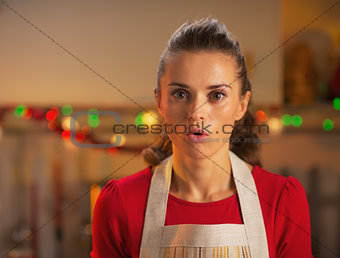 Portrait of surprised young housewife in christmas decorated kit