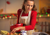 Young housewife preparing christmas dinner in kitchen