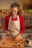 Happy young housewife chopping walnuts