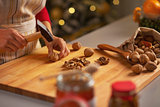 Closeup on housewife chopping walnuts