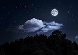 Night starry sky and moon over the mountain