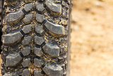 Tread tire coated in mud