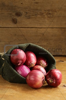 organic red onion on a wooden table