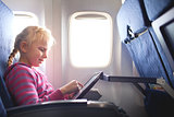 gilrl with ipad in the plane