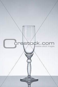Empty champagne glass on grey background 