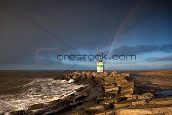 rainbow over lighthouse and North sea