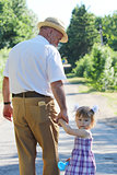 grandfather with his granddaughter are on the road