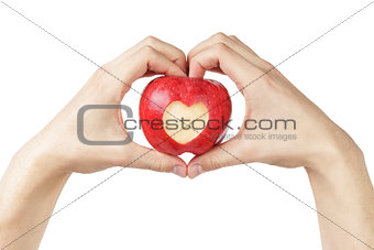 adult man hands holding apple with carved heart