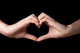 female teen hands showing heart symbol