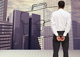 Composite image of rear view of young businessman wearing handcuffs