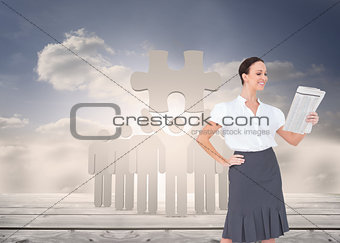 Composite image of cheerful stylish businesswoman holding newspaper