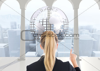 Composite image of business woman pointing somewhere