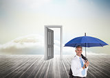 Composite image of businessman holding umbrella smiling at camera