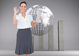 Composite image of stylish businesswoman making gesture while holding newspaper