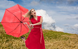 Composite image of elegant blonde holding umbrella