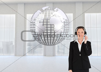 Composite image of good looking woman in suit using headphones and posing