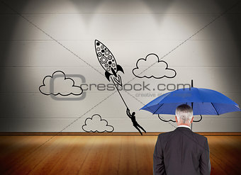 Composite image of businessman holding umbrella