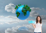 Composite image of content casual brunette holding a present