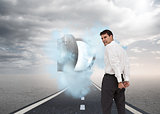 Composite image of rear view of young businessman wearing handcuffs