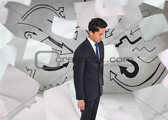 Composite image of stern businessman looking down