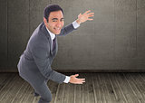 Composite image of excited businessman catching