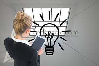 Composite image of businesswoman holding new tablet