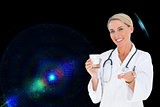 Composite image of happy doctor holding out pills and water glass