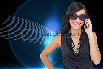 Composite image of happy brunette phoning