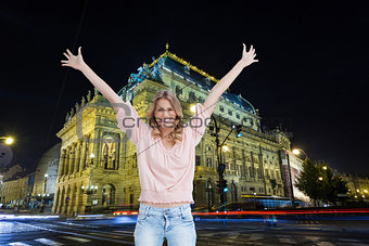Composite image of full length shot of a smiling woman with her arms raised up