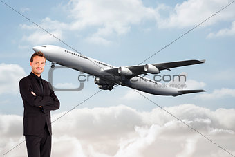 Composite image of handsome businessman with crossed arms