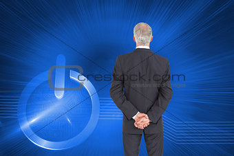 Composite image of rear view of serious businessman posing