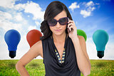 Composite image of serious elegant brunette wearing sunglasses on the phone