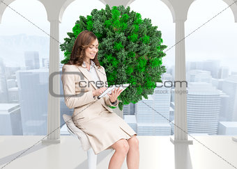 Composite image of happy businesswoman using tablet