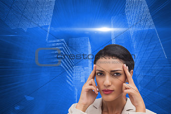 Composite image of young businesswoman putting her fingers on her temples