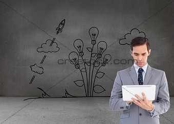 Composite image of businessman holding a tablet computer