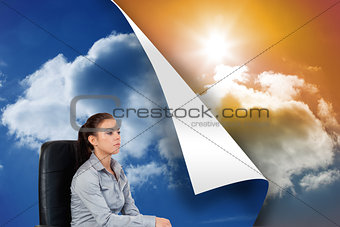Composite image of portrait of a serious businesswoman sitting on an armchair