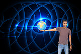 Composite image of handsome man holding out a globe