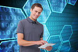 Composite image of smiling young man with tablet computer